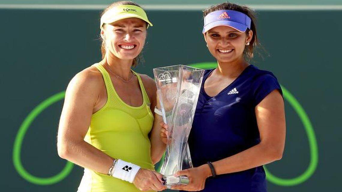
Martina Hingis of Switzerland and Sania Mirza of India pose with the Butch Buchholz Trophy after defeating Ekaterina Makarova and Elena Vesnina of Russia during the doubles final on day 14 of the Miami Open Presented by Itau at Crandon Park Tennis Center on April 5, 2015 in Key Biscayne, Florida.
