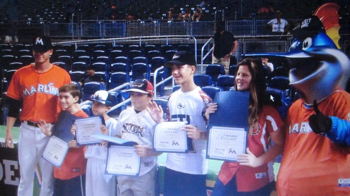 
Miami Marlins pitcher Scott McGough and lovable mascot Billy the Marlin congratulate the August honorees of the Miami Marlins/Miami Herald Team Player Program at Marlins Park. The standout student athletes are Alessandro Fernandez (St. Thomas the Apostle Catholic School), Hudson Koczwara (Ruth K. Broad Bay Harbor K-8 Center), Mario Menendez (Island Christian School), Ryan Mittleman (Nova High School) and Eva Sirlin (Miami Country Day School).


