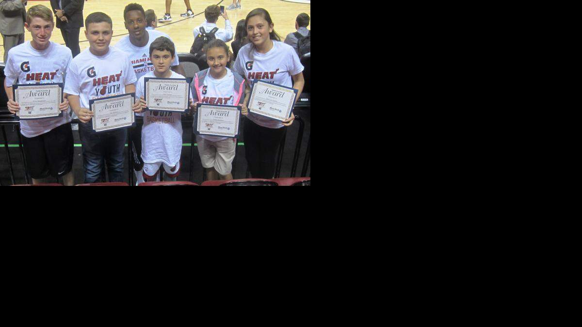 
Miami Heat guard Mario Chalmers, a two-time NBA champion, congratulates from left, Bay Harbor Islands’ Evan Mendelson (Miami Country Day School), Miami’s Sal Stewart (Pinecrest Cove Preparatory Academy), Miami’s Jack Furman (Virginia A. Boone Highland Oaks Elementary School), Miami’s Julieta Martinez (Springview Elementary School) and Pembroke Pines’ Maylizze Santos (Our Lady of the Lakes School). They were honored as the Miami Heat/Miami Herald February Academic/Sportsmanship Team Players in conjunction with Gatorade, before the Heat/Philadelphia 76ers game at the AmericanAirlines Arena.
