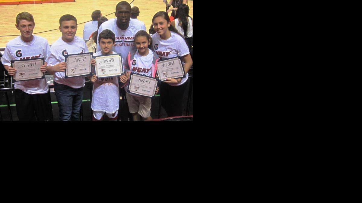 
Miami Heat forward Luol Deng congratulates from left, Bay Harbor Islands’ Evan Mendelson (Miami Country Day School), Miami’s Sal Stewart (Pinecrest Cove Preparatory Academy), Miami’s Jack Furman (Virginia A. Boone Highland Oaks Elementary School), Miami’s Julieta Martinez (Springview Elementary School) and Pembroke Pines’ Maylizze Santos (Our Lady of the Lakes School). They were honored as the Miami Heat/Miami Herald February Academic/Sportsmanship Team Players in conjunction with Gatorade, before the Heat/Philadelphia 76ers game at the AmericanAirlines Arena.
