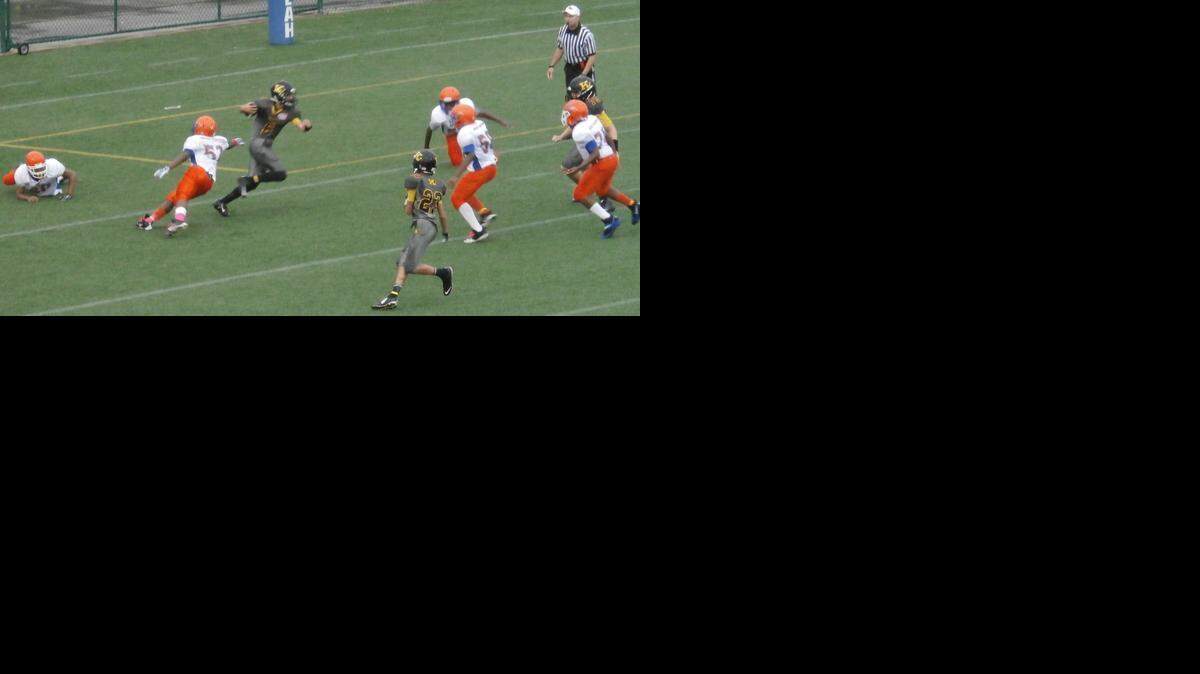 
Ari Arteaga (6) of the Kendall Boys & Girls Club Kolts tries to avoid the defense of the South Kendall Gators in a 12U (130 pound) semifinal of the Miami Xtreme Youth Football League at Ted Hendricks Stadium at Milander Park in Hialeah.

