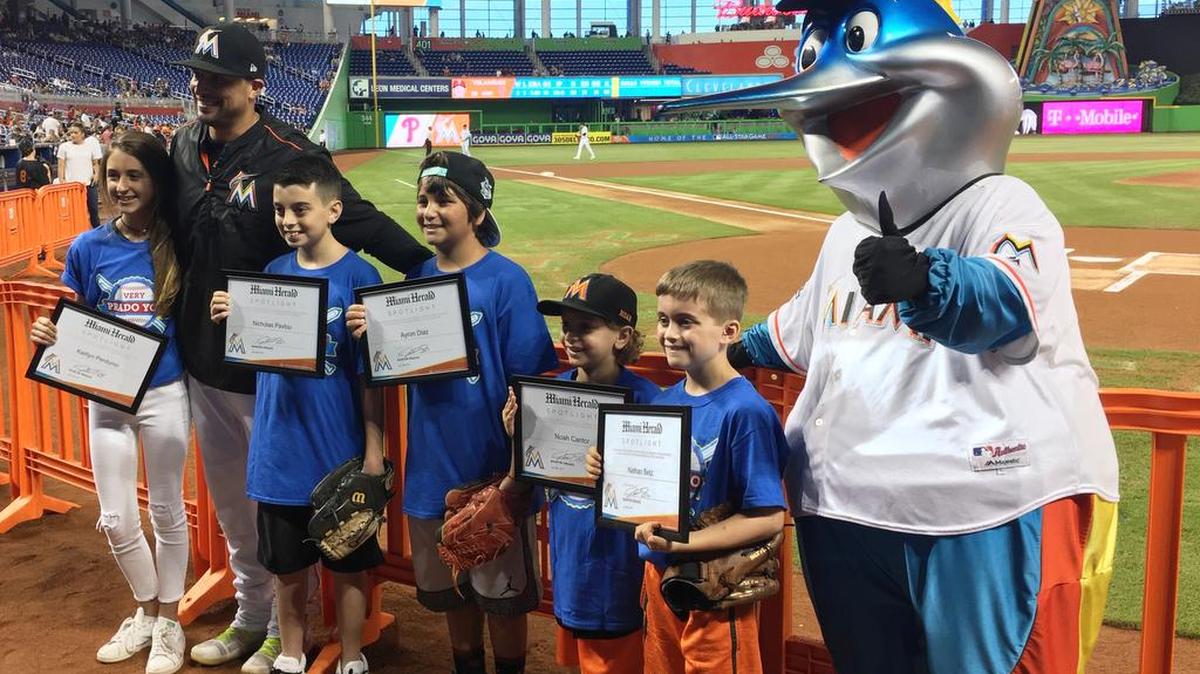 Miami Marlins third baseman Martin Prado congratulated the July honorees of the Very Prado You student athlete (baseball/softball) program in conjunction with the Miami Herald and the Marlins. (From left) Kaitlyn Perdomo (Saint Louis Covenant School), Nicholas Pavlou (Herbert A. Ammons Middle School), Ayron Diaz (West Hialeah Gardens Elementary School), Noah Cantor (North Beach Elementary School), and Nathan Betz (Calvary Christian Academy) were recognized for their academics and sportsmanship at a ceremony behind home plate before the Marlins game against the Philadelphia Phillies at Marlins Park. Prado provided an autographed certificate of achievement, four game tickets, food and beverage, parking, and a Very Prado You T-shirt. The honorees met Prado earlier in the dugout and attended batting practice. Mascot extraordinaire Billy the Marlin also participated.