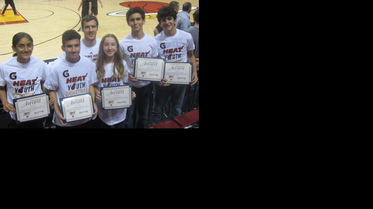 
Miami Heat guard Goran Dragic congratulated (from left) Maria Alvarez (Miami Country Day School), Ulises Hernandez III (Our Lady of the Lakes School), Emily Davidovic (Hochberg Preparatory School), Nicolas Aixala (Conchita Espinosa Academy), and Sebastian Vidal-Casanova (St. Patrick School) for being the Miami Heat/Miami Herald March Academic/Sportsmanship Team Players in conjunction with Gatorade at the AmericanAirlines Arena. They were honored on the court before the Heat’s win against the Portland Trailblazers.
