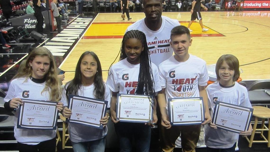 Miami Heat forward Luol Deng congratulates Ariel Fishman (Hochberg Prep), Amanda Ramos (Pinecrest Preparatory), Anise Wooten (Cushman School), Brian Orosa (Devon Aire K-8 Center), and Jack Dillon (Aventura Charter School) for being the Miami Heat/Miami Herald January Academic/Sportsmanship Team Players in conjunction with Gatorade. They were later honored on the court before the Heat/Milwaukee Bucks game at the AmericanAirlines Arena.