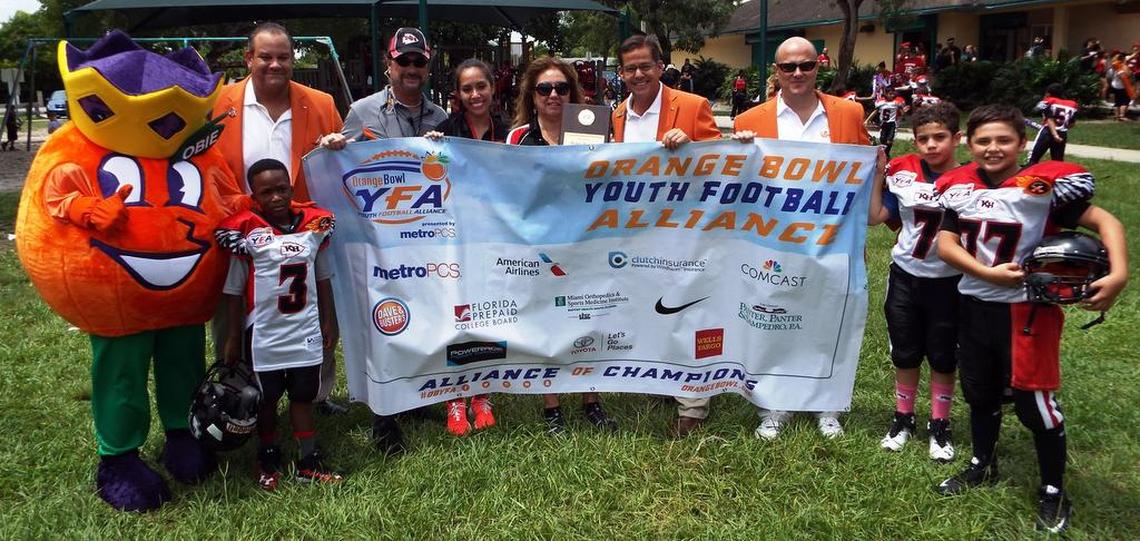 Orange Bowl mascot OBIE and Orange Bowl Committee members Sergio Abreu, George Pino and Albert de Cardenas along with Kendall Hammocks Warriors reps Mike Pintado, Meylin Castro and Shirley Pintado and their players in 2016.